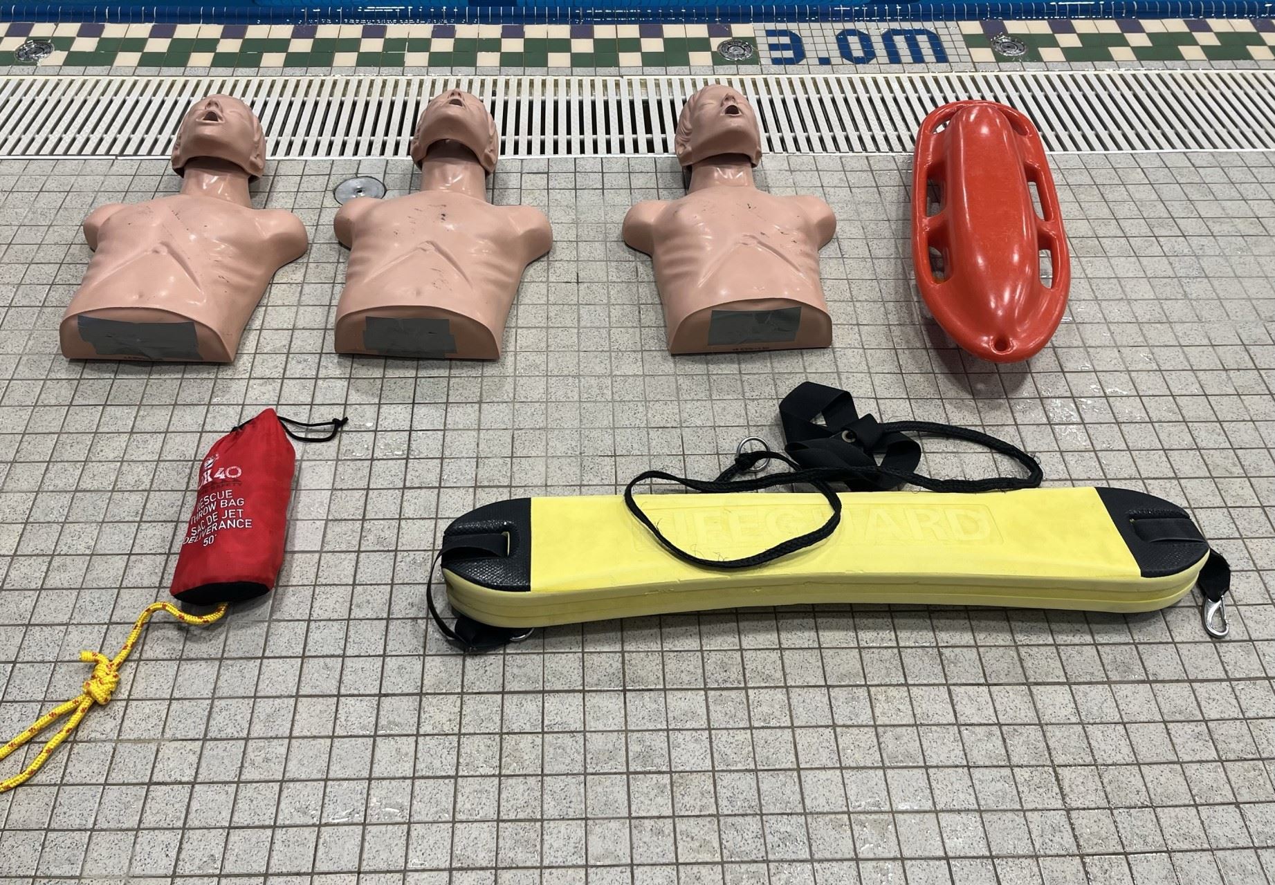 First Aid Course Equipment Including CPR Dummies and Floatation Devices